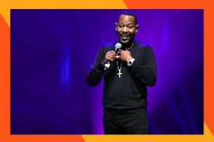 Comedian Martin Lawrence smiles while performing onstage.