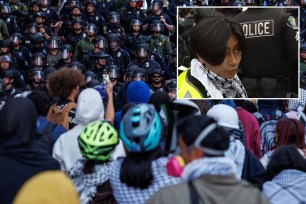 A group of people wearing helmets and a woman standing amidst a crowd